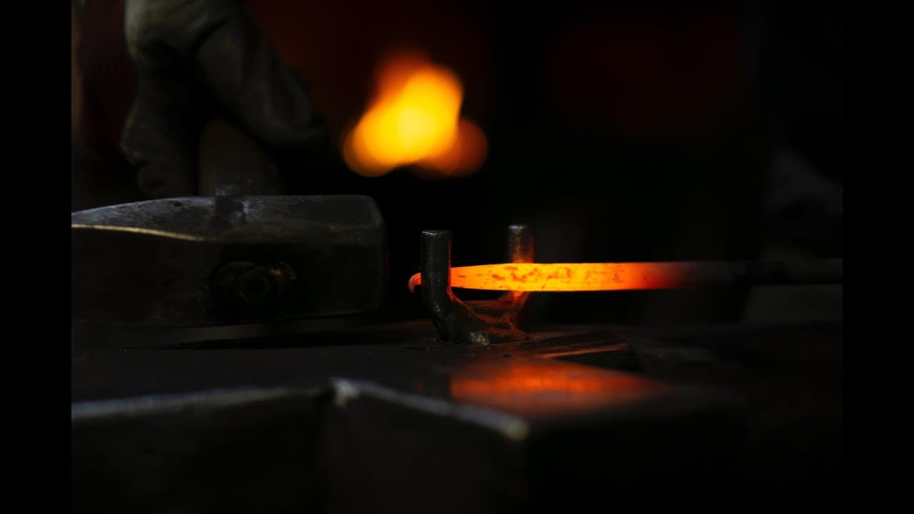 A still from the short film The Blacksmith: Judson Dunne at the anvil in the shop he built