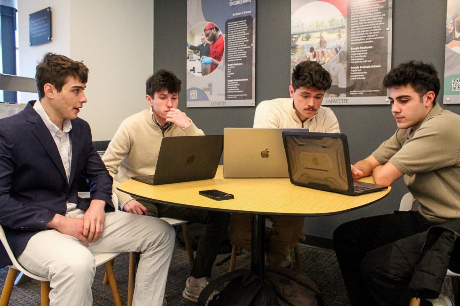 Judson Dunne working with the Locava team around a table at Lafayette College