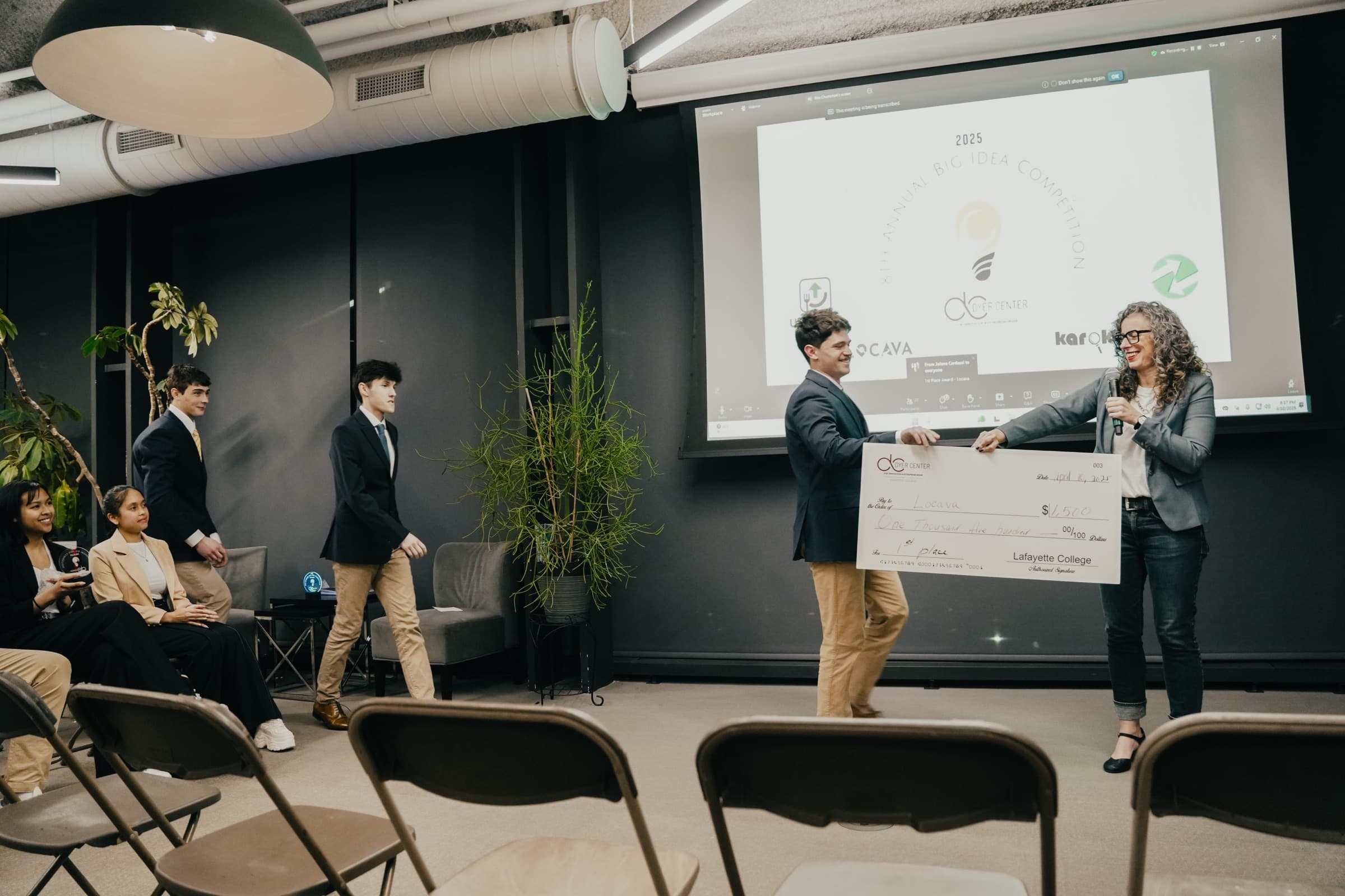 Judson accepting the first-place cheque at the Big Idea Pitch Competition
