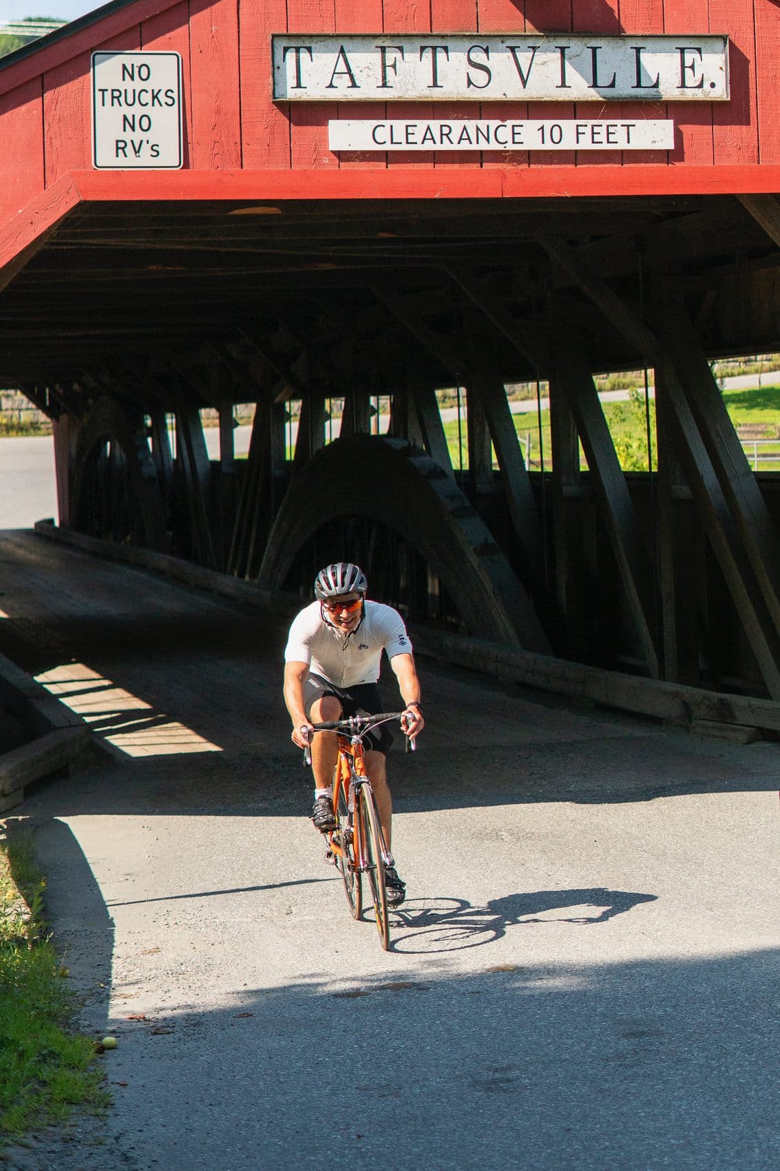 Judson riding through a Vermont covered bridge